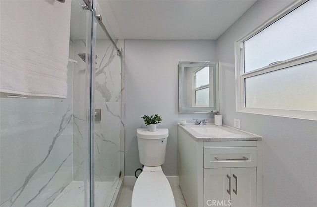 bathroom featuring vanity, toilet, and a shower with door