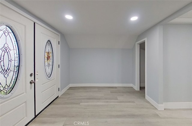 entrance foyer with light hardwood / wood-style floors and vaulted ceiling