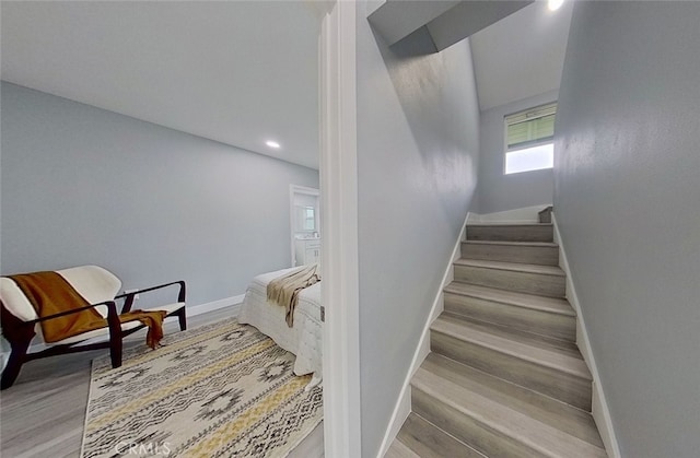 staircase with hardwood / wood-style flooring