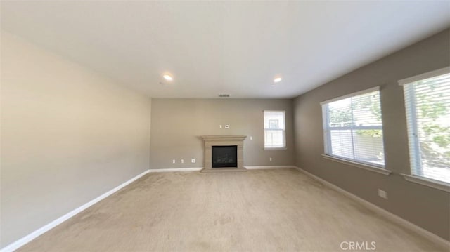 unfurnished living room with light colored carpet