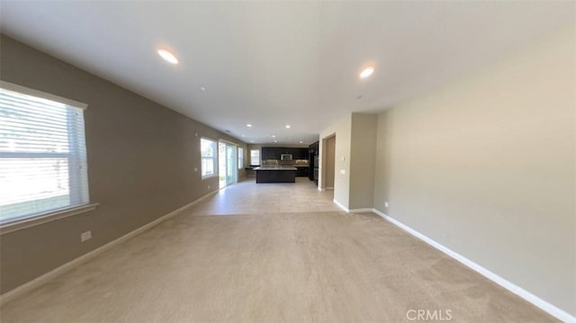 hallway with light colored carpet