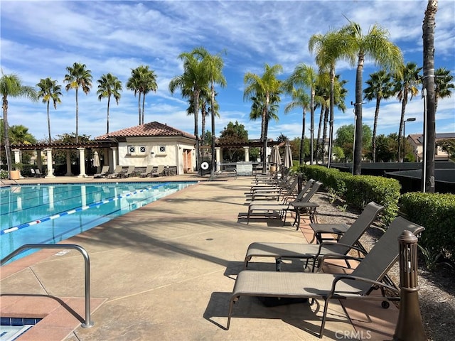 view of pool with a patio area and an outbuilding