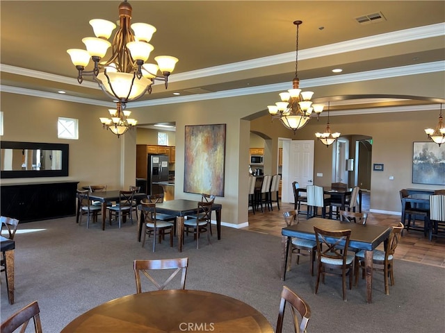 dining area featuring a tray ceiling, crown molding, and carpet flooring