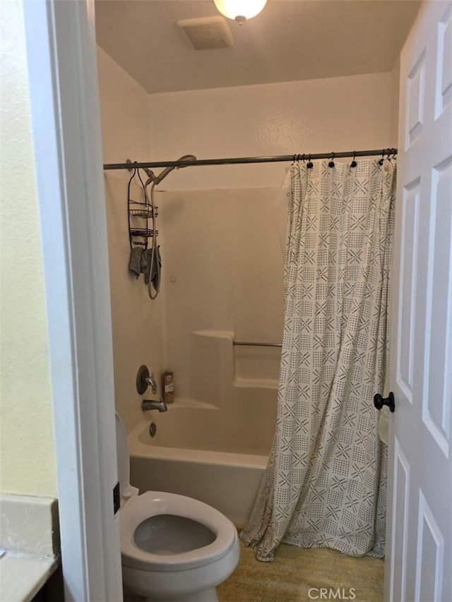 bathroom with hardwood / wood-style floors, toilet, and shower / bathtub combination with curtain