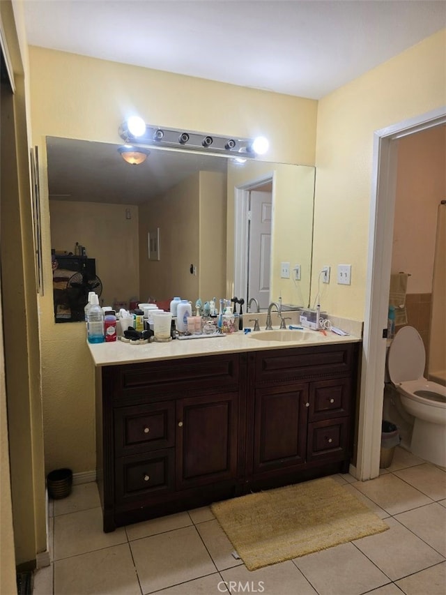 bathroom with tile patterned flooring, vanity, and toilet