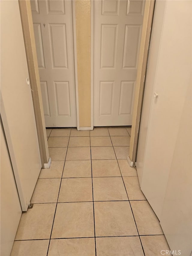 hallway featuring light tile patterned floors