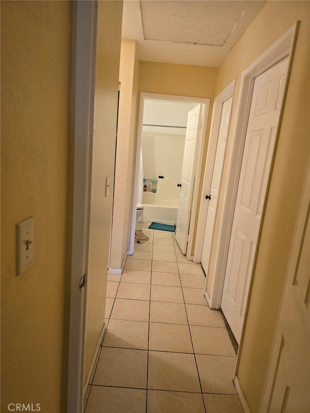 corridor with light tile patterned floors