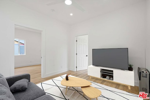 living room featuring ceiling fan and light hardwood / wood-style floors