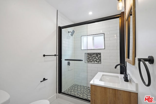 bathroom with an enclosed shower, vanity, and toilet