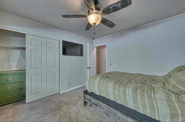 carpeted bedroom featuring ceiling fan and a closet