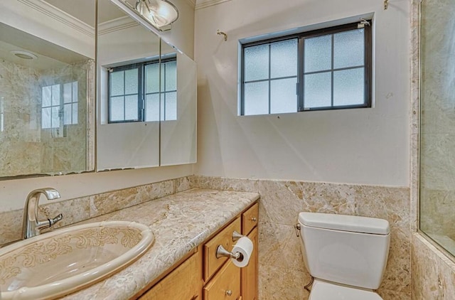 bathroom featuring toilet, crown molding, tile walls, and vanity