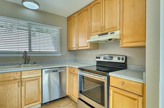 kitchen featuring light tile patterned floors, stainless steel appliances, light brown cabinetry, and sink