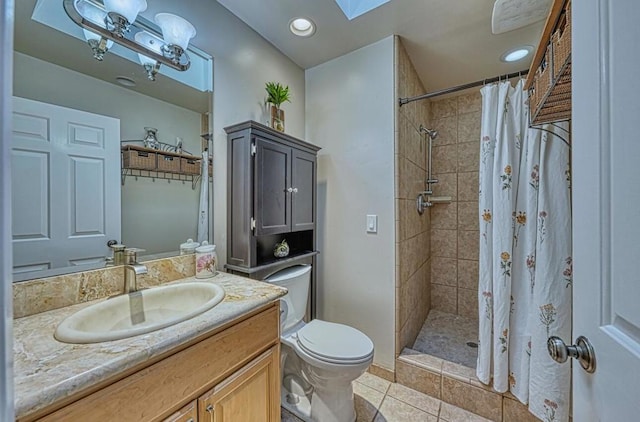 bathroom featuring tile patterned flooring, vanity, a skylight, toilet, and a shower with shower curtain