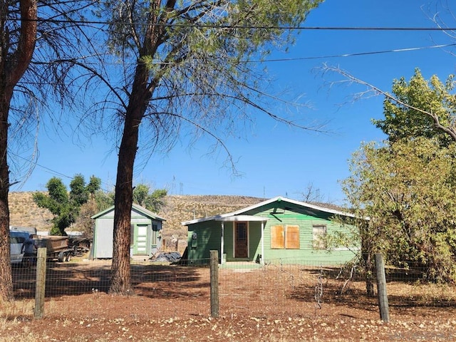 rear view of property with a shed