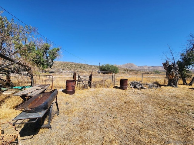 view of yard featuring a mountain view and a rural view