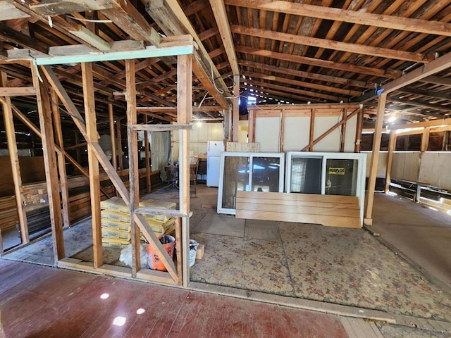 misc room with lofted ceiling and dark wood-type flooring