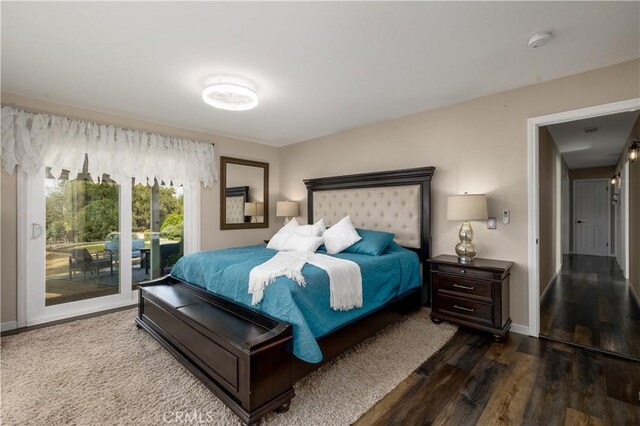 bedroom featuring access to exterior and wood-type flooring