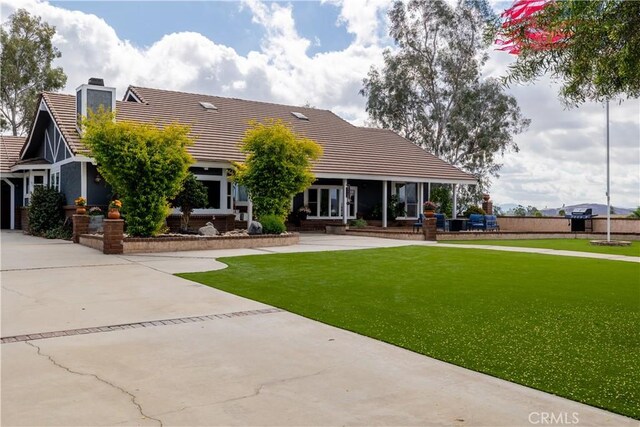 rear view of house featuring a yard