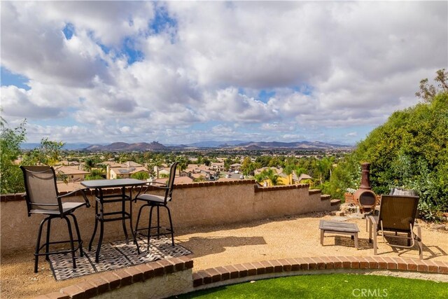 view of patio with a fireplace and a mountain view