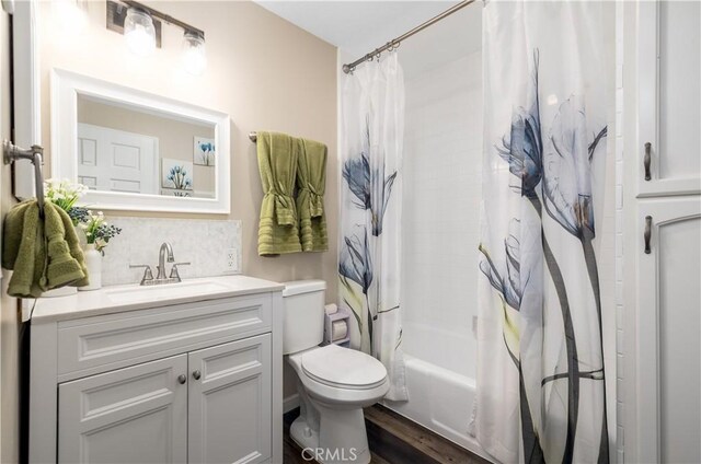 full bathroom with backsplash, vanity, shower / bathtub combination with curtain, and toilet