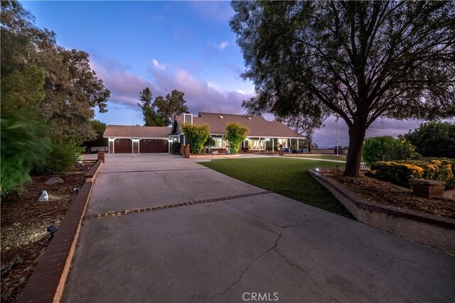 view of front of house with a garage and a lawn