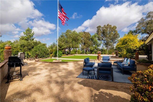 view of community featuring a patio and an outdoor hangout area