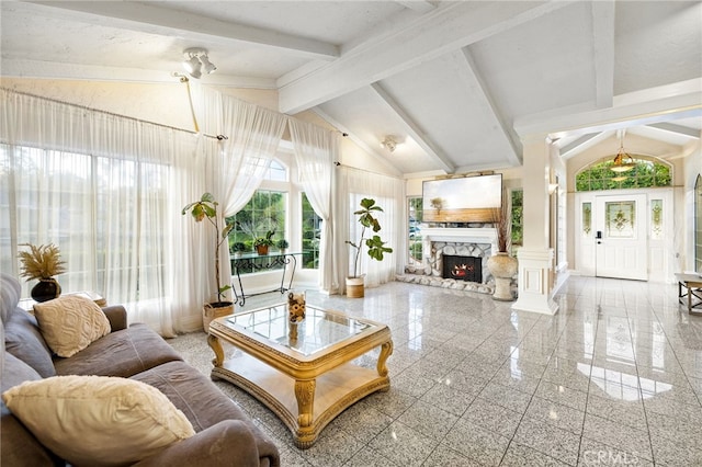 living room featuring beamed ceiling, ornate columns, a fireplace, and high vaulted ceiling