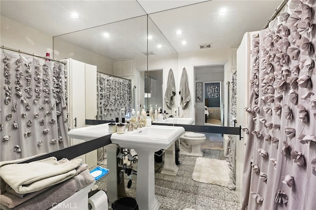 bathroom with toilet and curtained shower