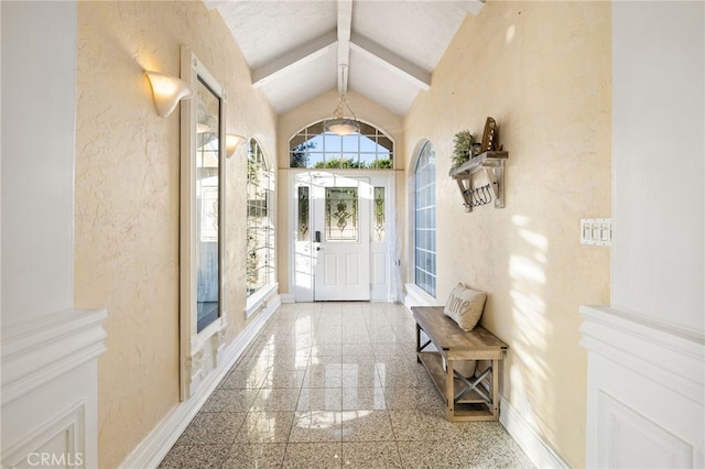 foyer featuring lofted ceiling with beams