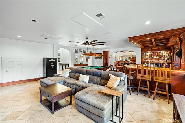 living room with pool table, indoor bar, light tile patterned floors, and ceiling fan