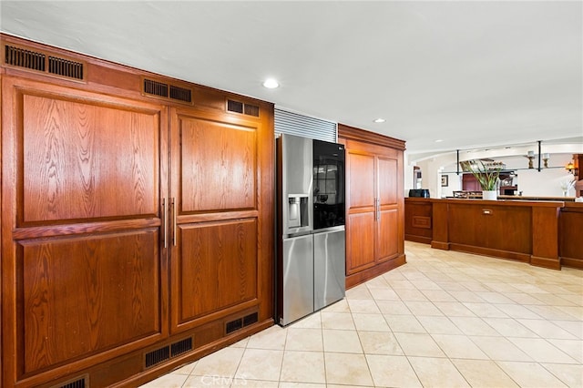 kitchen with stainless steel fridge and light tile patterned floors