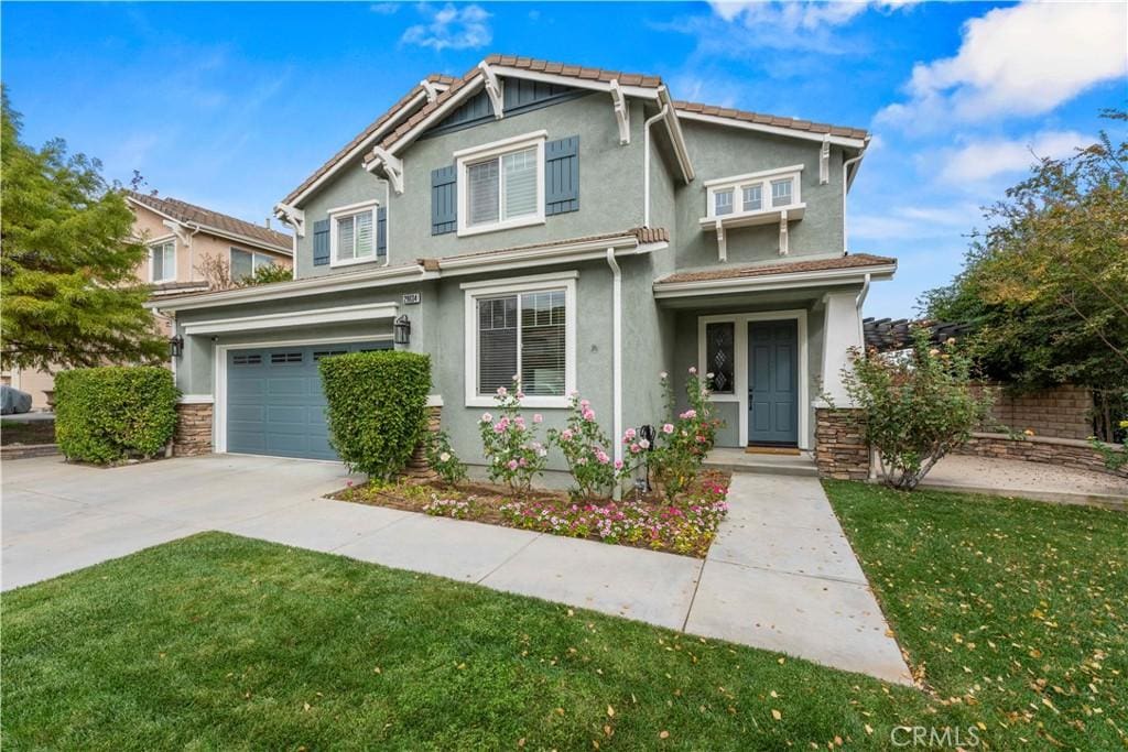 view of front of house with a garage and a front lawn