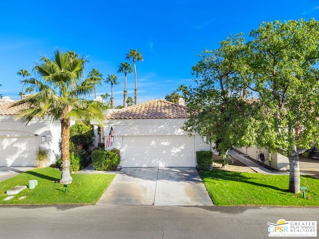 view of front of property featuring a garage and a front lawn