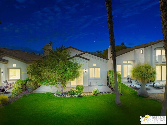 exterior space featuring a lawn and a patio