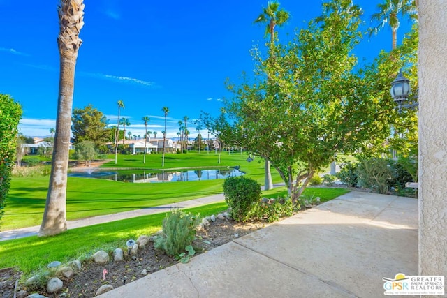 view of community featuring a lawn and a water view