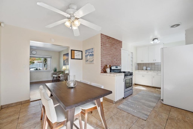 tiled dining space featuring ceiling fan