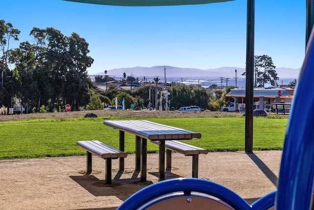 view of property's community featuring a mountain view and a lawn