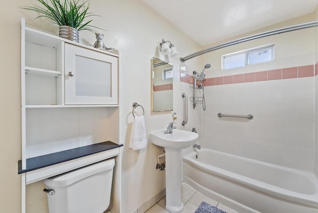 full bathroom with toilet, tiled shower / bath, tile patterned floors, and sink