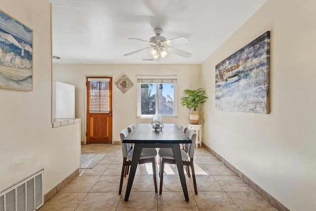 dining space featuring ceiling fan and light tile patterned flooring