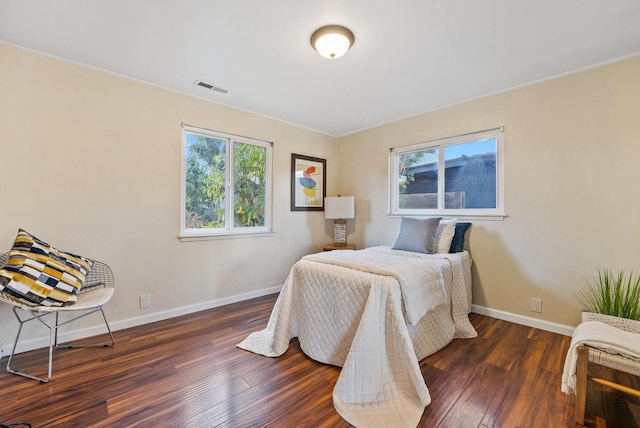 bedroom with dark hardwood / wood-style floors