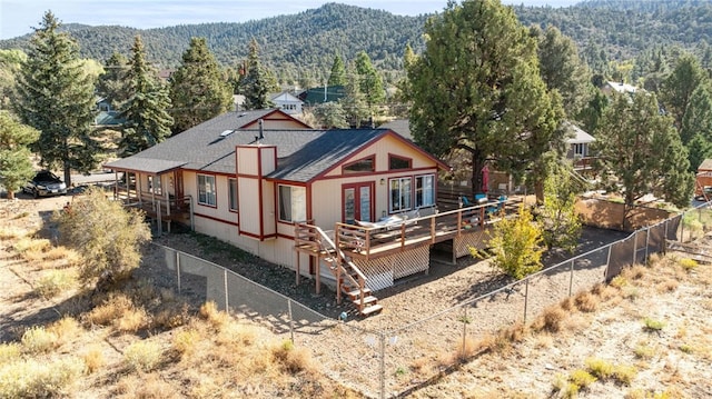 rear view of house with a deck with mountain view