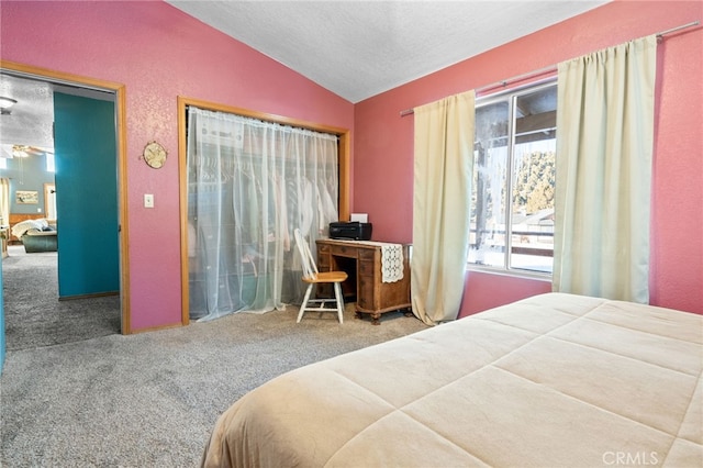 carpeted bedroom with lofted ceiling and a textured ceiling