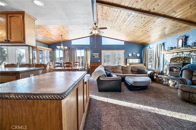 kitchen featuring dark carpet, vaulted ceiling with beams, a kitchen island, wood ceiling, and ceiling fan with notable chandelier