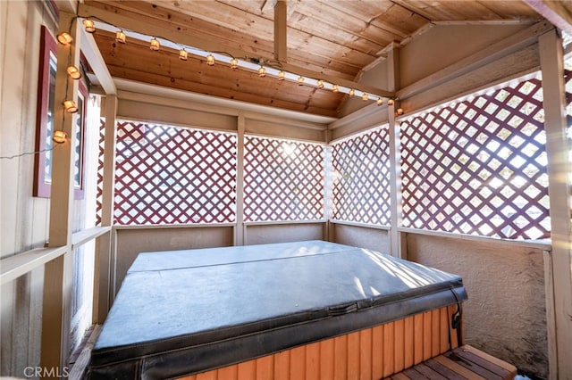 wooden terrace featuring a hot tub