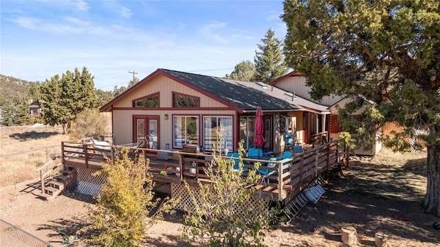 rear view of house featuring french doors and a deck