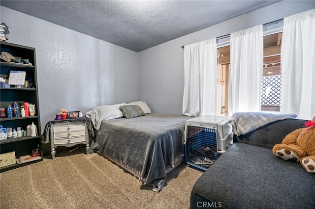 bedroom featuring carpet floors and a textured ceiling