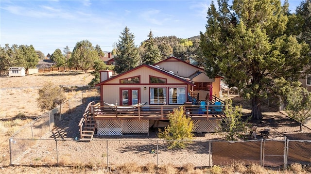 back of house with french doors and a deck