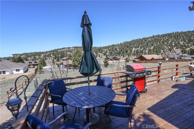 view of patio / terrace with a wooden deck and a grill