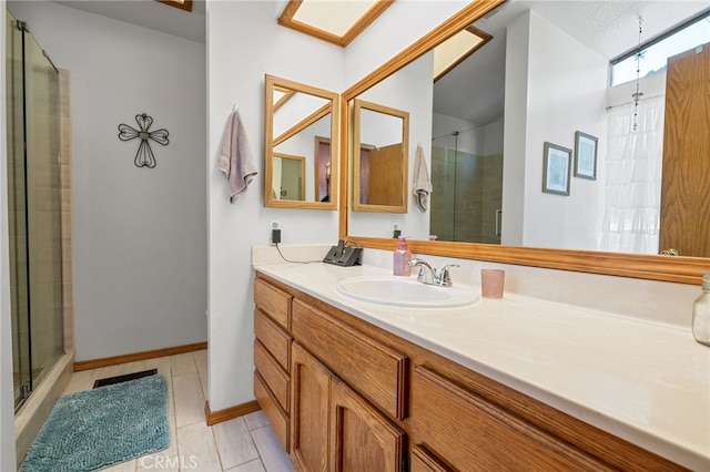 bathroom featuring tile patterned flooring, vanity, and walk in shower