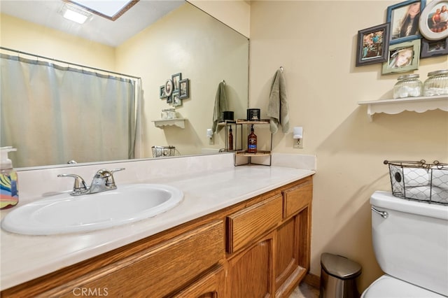 bathroom featuring walk in shower, vanity, and toilet